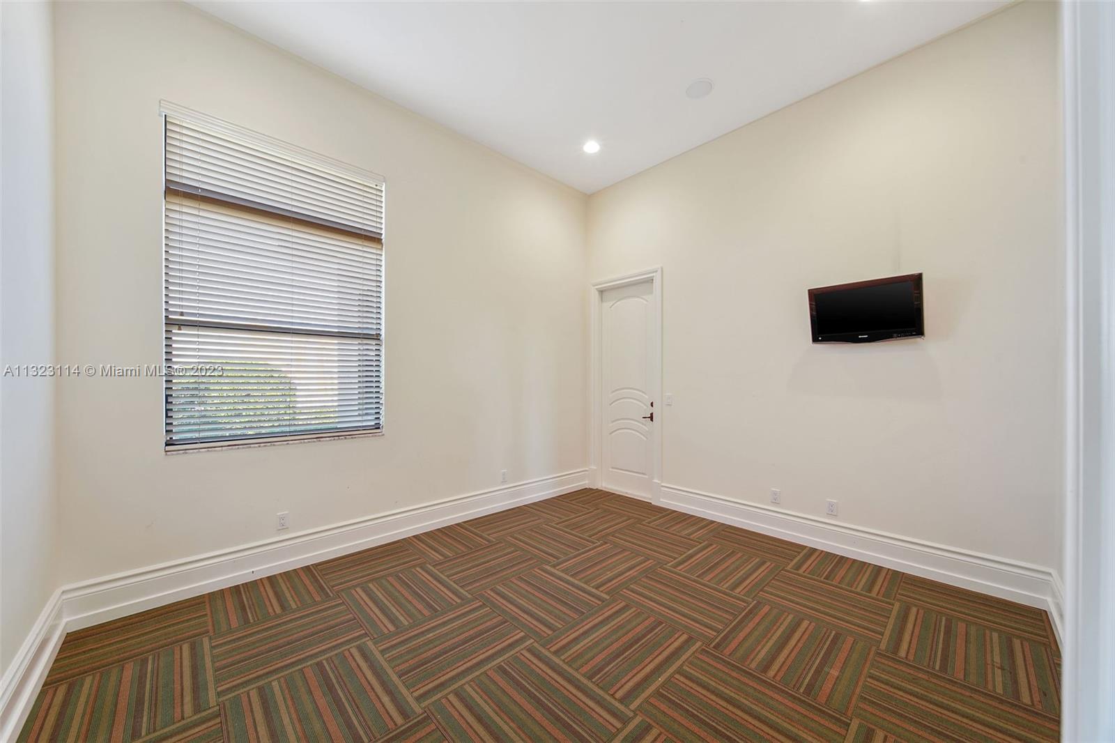 2863 Lake Ridge Lane Weston, FL 33332 - Photo 34 of 60 a view of room with wooden floor and window