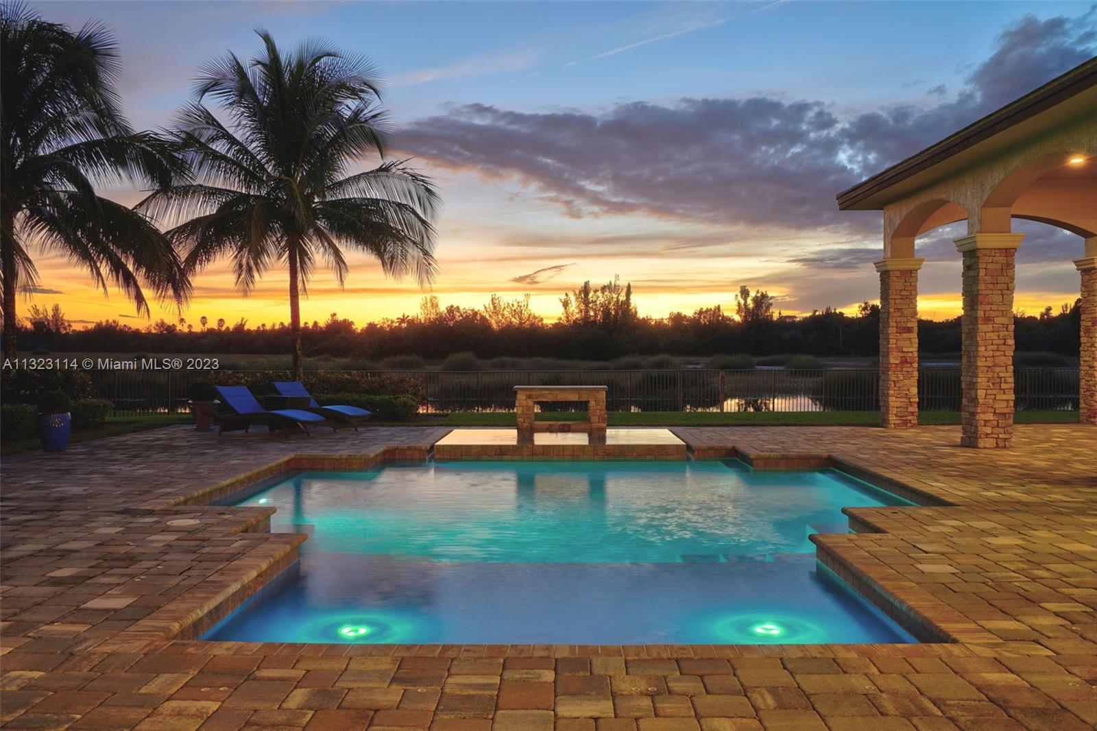 2863 Lake Ridge Lane Weston, FL 33332 - Photo 40 of 60 a view of swimming pool with a table and chairs