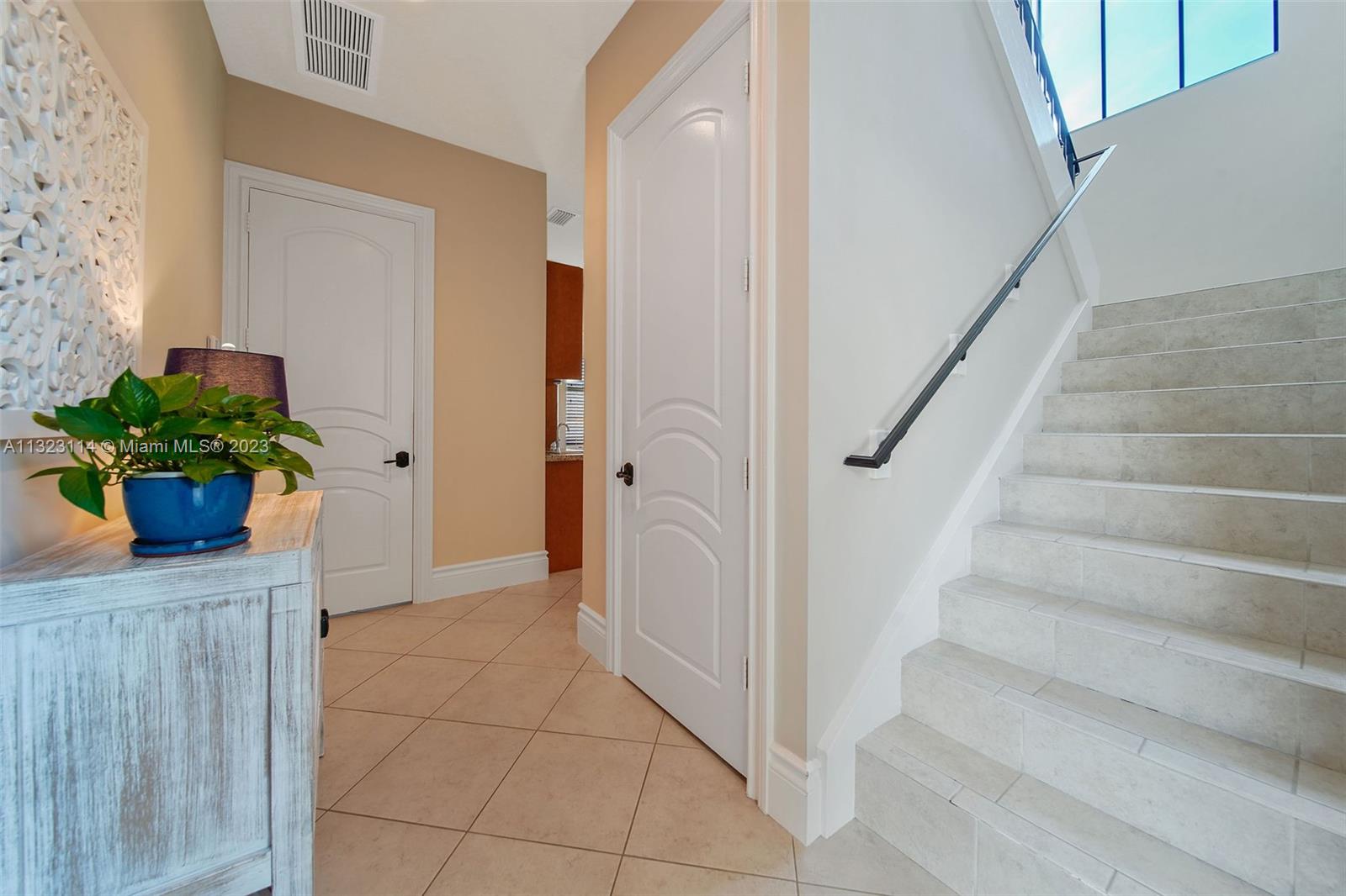 2863 Lake Ridge Lane Weston, FL 33332 - Photo 45 of 60 a view of entryway with wooden floor and a potted plant