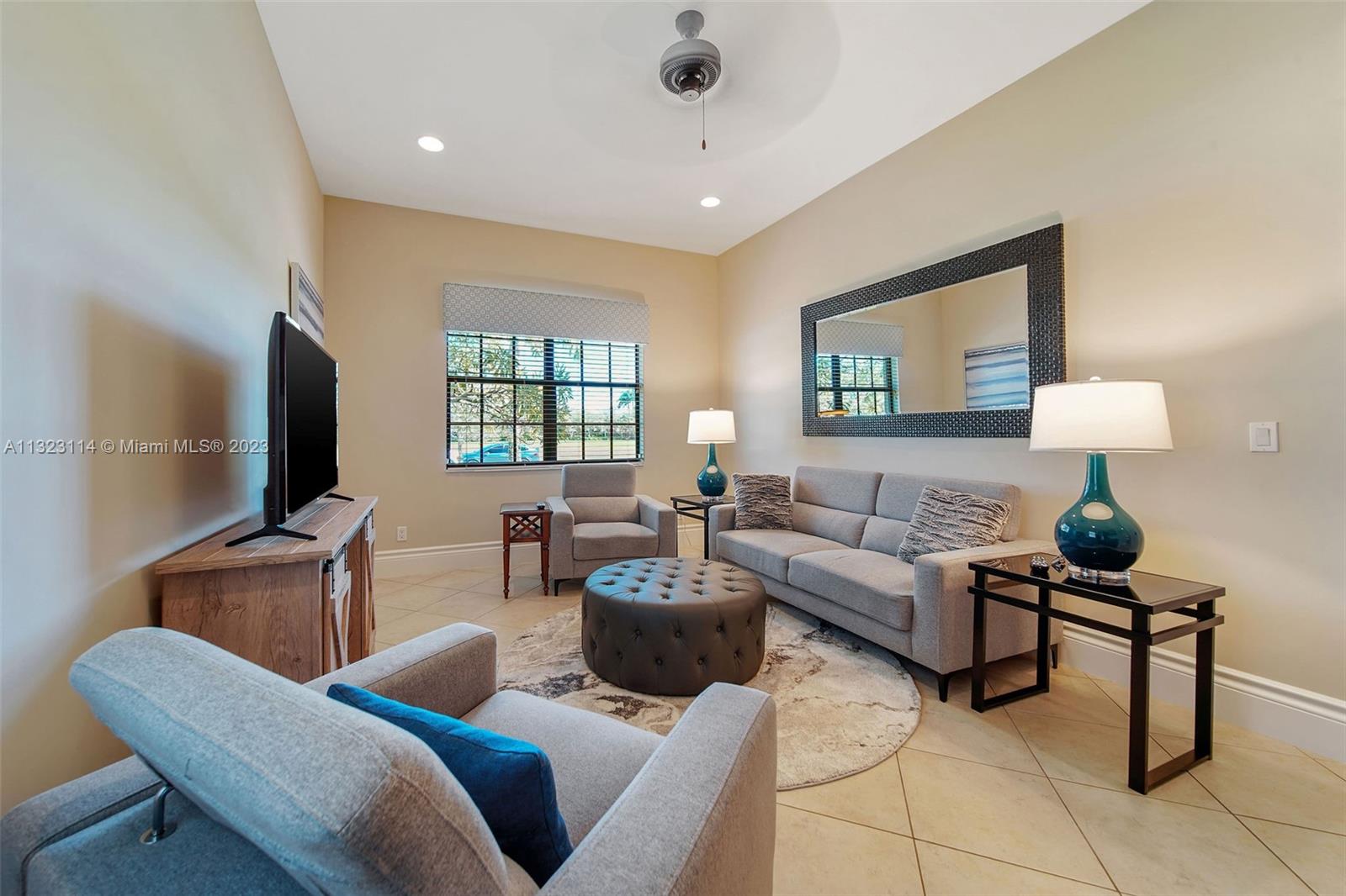 2863 Lake Ridge Lane Weston, FL 33332 - Photo 46 of 60 a living room with furniture and a flat screen tv