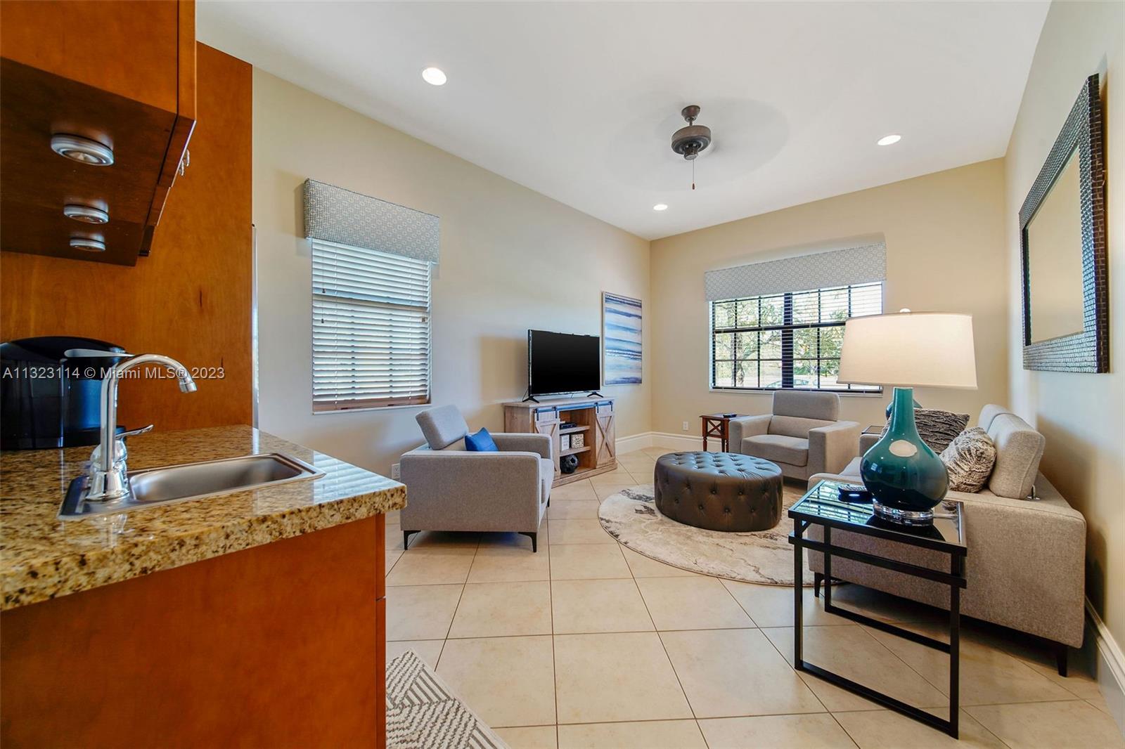 2863 Lake Ridge Lane Weston, FL 33332 - Photo 47 of 60 a living room with furniture and a flat screen tv