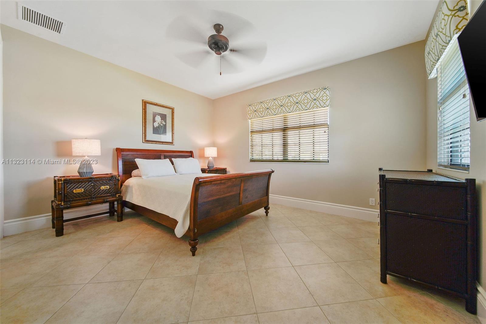 2863 Lake Ridge Lane Weston, FL 33332 - Photo 49 of 60 a bedroom with a bed and a dresser