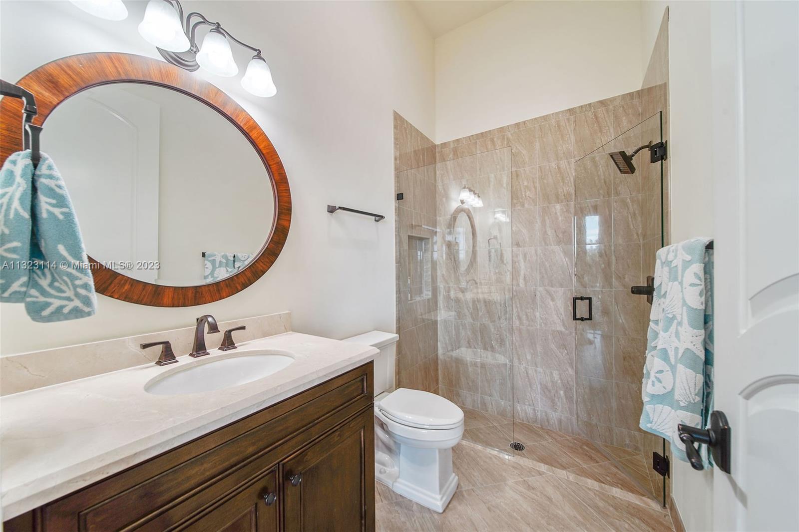 2863 Lake Ridge Lane Weston, FL 33332 - Photo 50 of 60 a bathroom with a sink a toilet and shower
