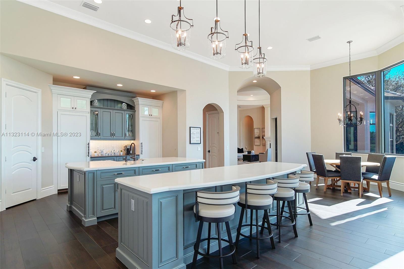 2863 Lake Ridge Lane Weston, FL 33332 - Photo 5 of 60 a large kitchen with a table and chairs