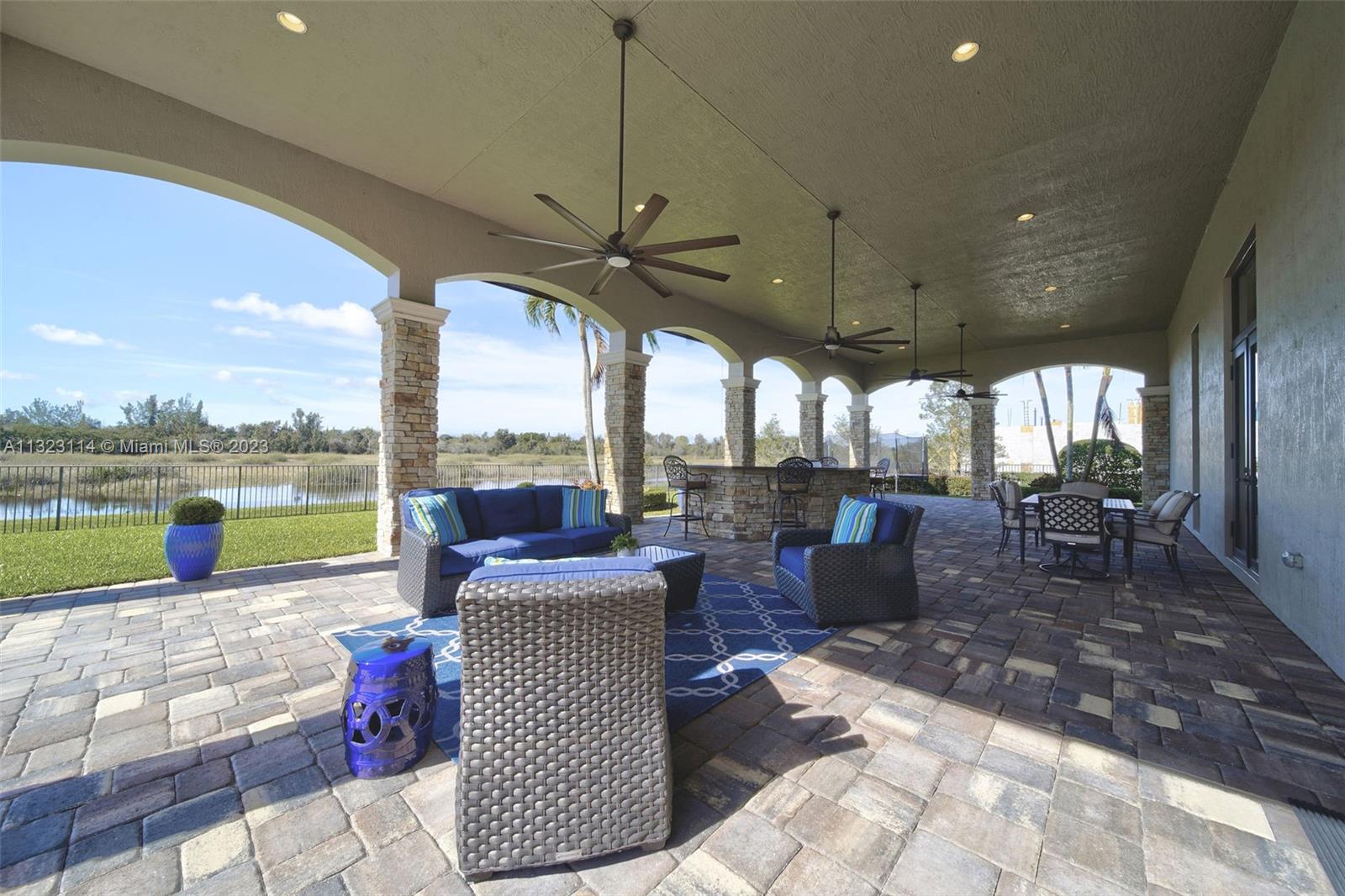 2863 Lake Ridge Lane Weston, FL 33332 - Photo 54 of 60 a living room with patio furniture and a floor to ceiling window