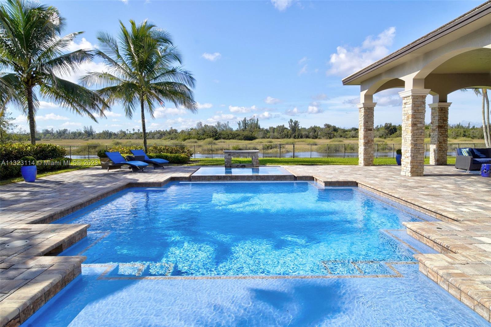 2863 Lake Ridge Lane Weston, FL 33332 - Photo 9 of 60 a view of swimming pool with outdoor seating and plants