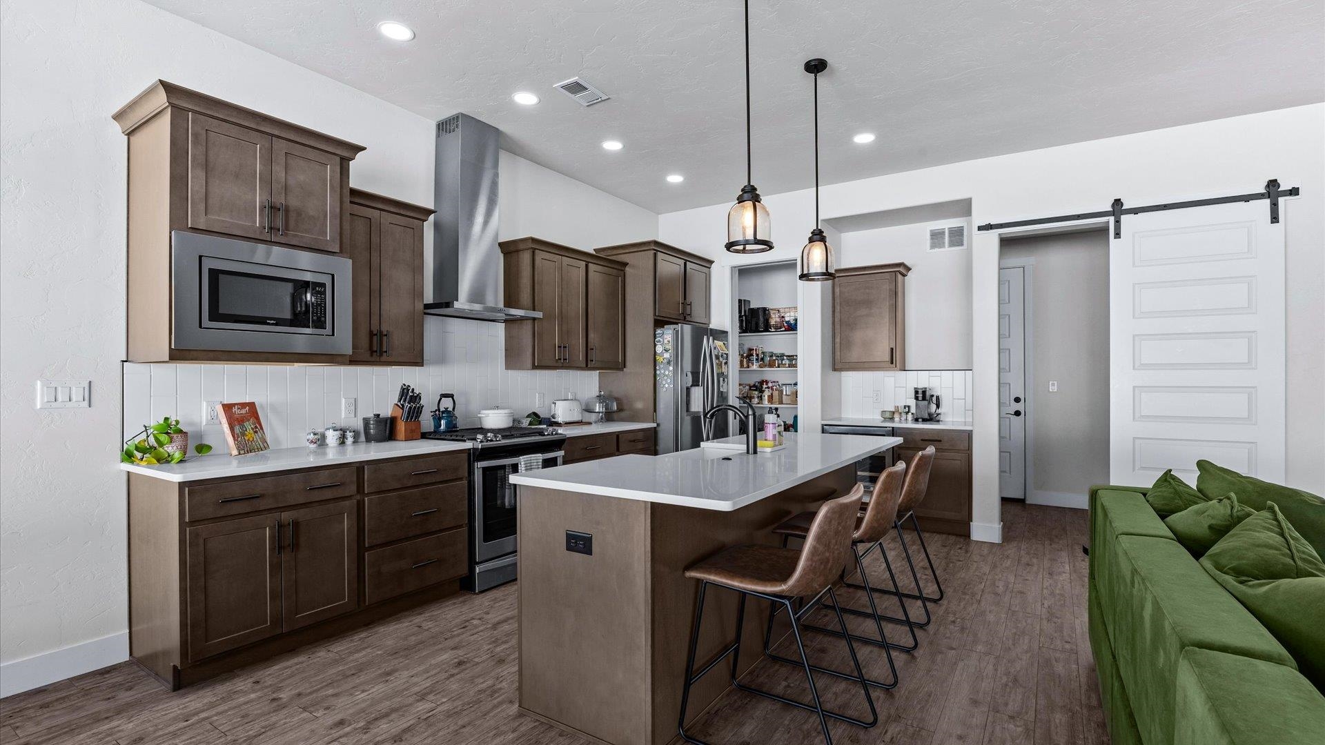 840 Rupp Avenue Palisade, CO 81526 - Photo 12 of 27 a kitchen with stainless steel appliances kitchen island granite countertop a stove a sink a refrigerator and a refrigerator