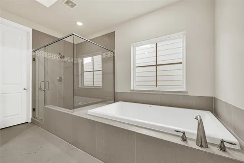 a bathroom with a bathtub and a shower