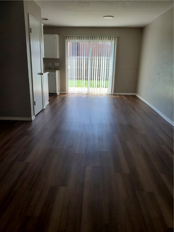 1102 Denver Street, Unit B Portland, TX 78374 - Photo 3 of 7 wooden floor in an empty room with a window