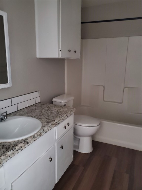 1102 Denver Street, Unit B Portland, TX 78374 - Photo 4 of 7 a bathroom with a granite countertop toilet sink and mirror
