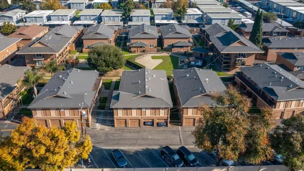 an aerial view of a houses with a swimming pool