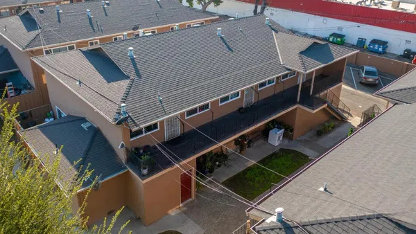 an aerial view of a house with a parking space
