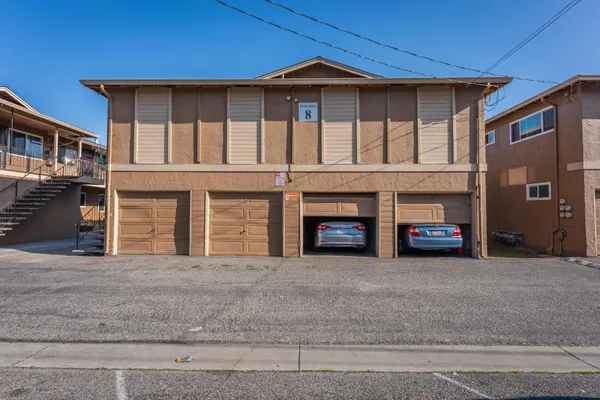 a view of a car park in front of a house
