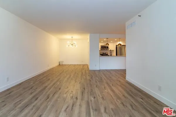 a view of a room with wooden floor