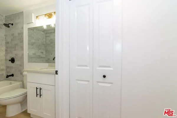 a bathroom with a shower a toilet and a sink