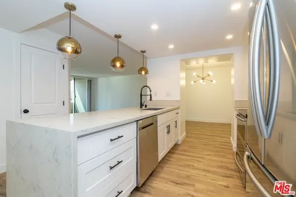 a bathroom with a sink a mirror and a shower