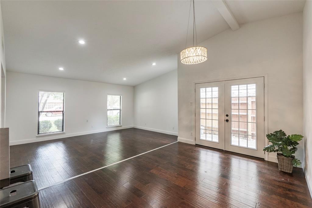 Modern chandelier and tons of natural light from the side patio in this large dining area