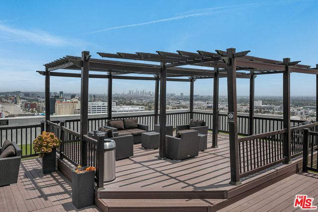 a view of a balcony with chairs and wooden floor