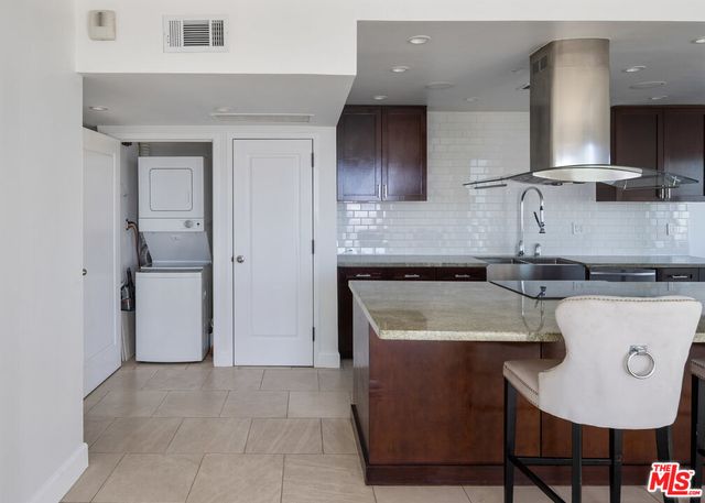 a kitchen with a sink a stove and cabinets