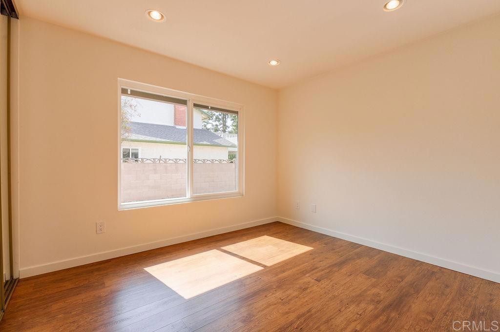 13321 Canyon Back Lane Poway, CA 92064 - Photo 16 of 26 an empty room with wooden floor and windows