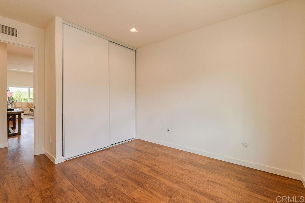 13321 Canyon Back Lane Poway, CA 92064 - Photo 17 of 26 a view of an empty room with wooden floor