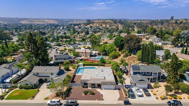 an aerial view of residential houses with outdoor space