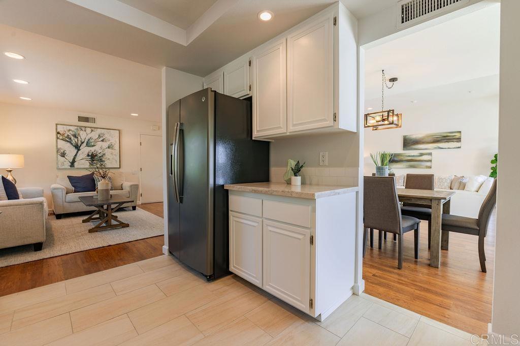 13321 Canyon Back Lane Poway, CA 92064 - Photo 10 of 26 a kitchen with a refrigerator and white cabinets