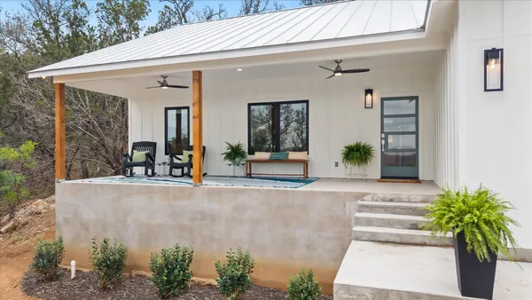 a view of a house with potted plants