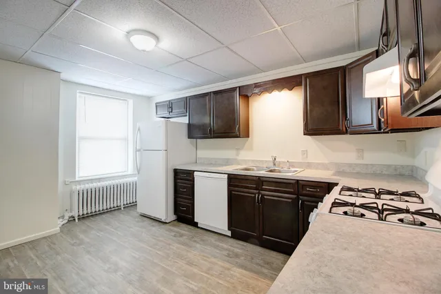 a kitchen with stainless steel appliances granite countertop a stove and a sink