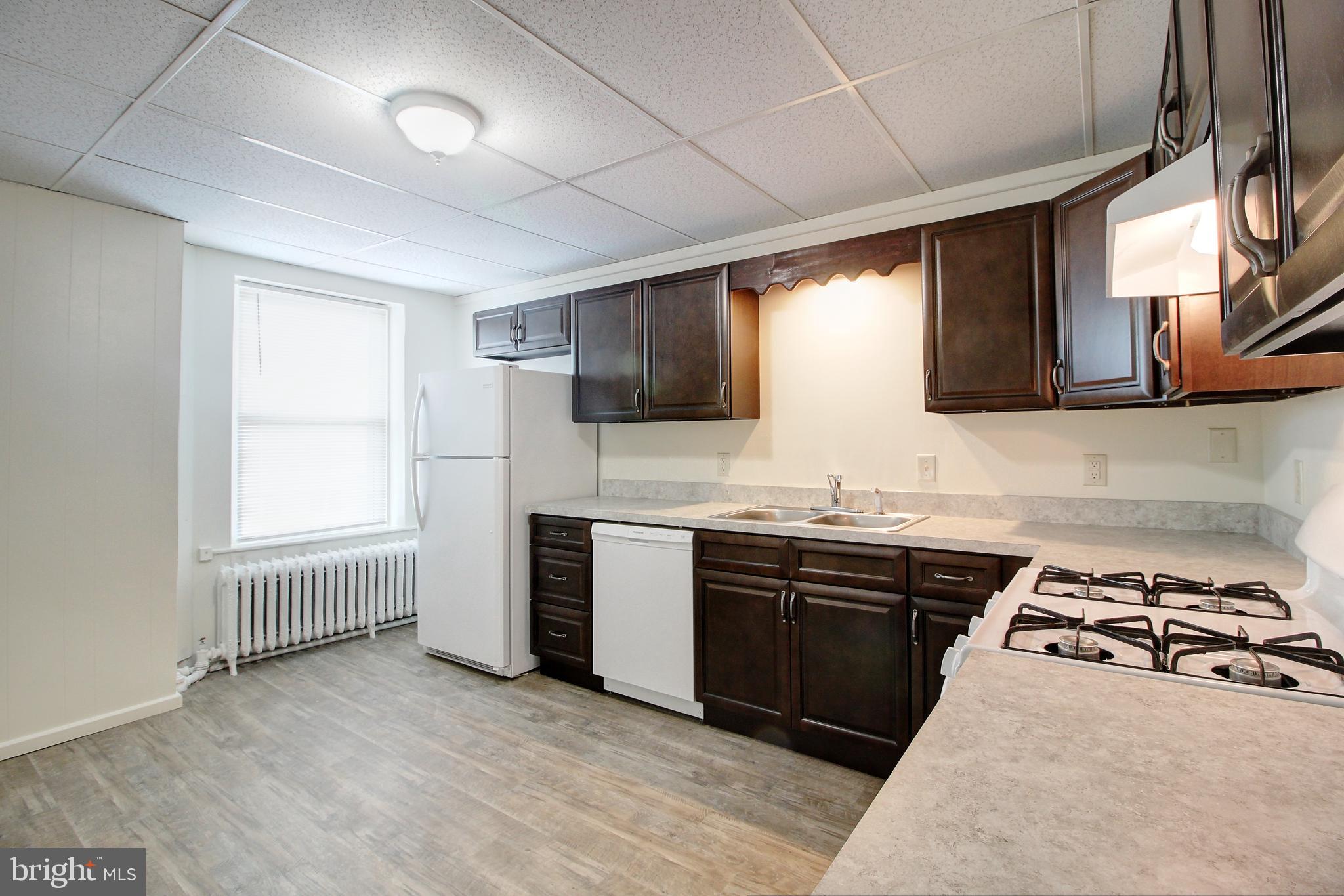 604 West Main Street, Unit 3 Emmitsburg, MD 21727 - Photo 2 of 13 a kitchen with stainless steel appliances granite countertop a stove and a sink