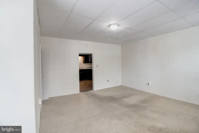 a view of an empty room with a kitchen