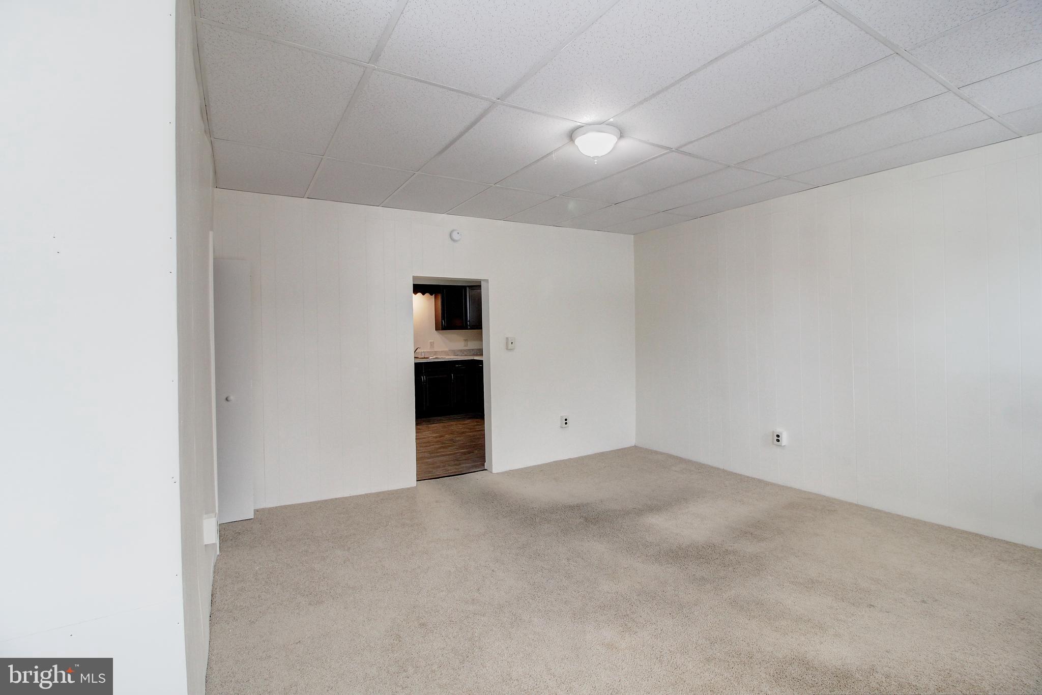 604 West Main Street, Unit 3 Emmitsburg, MD 21727 - Photo 5 of 13 a view of an empty room with a kitchen