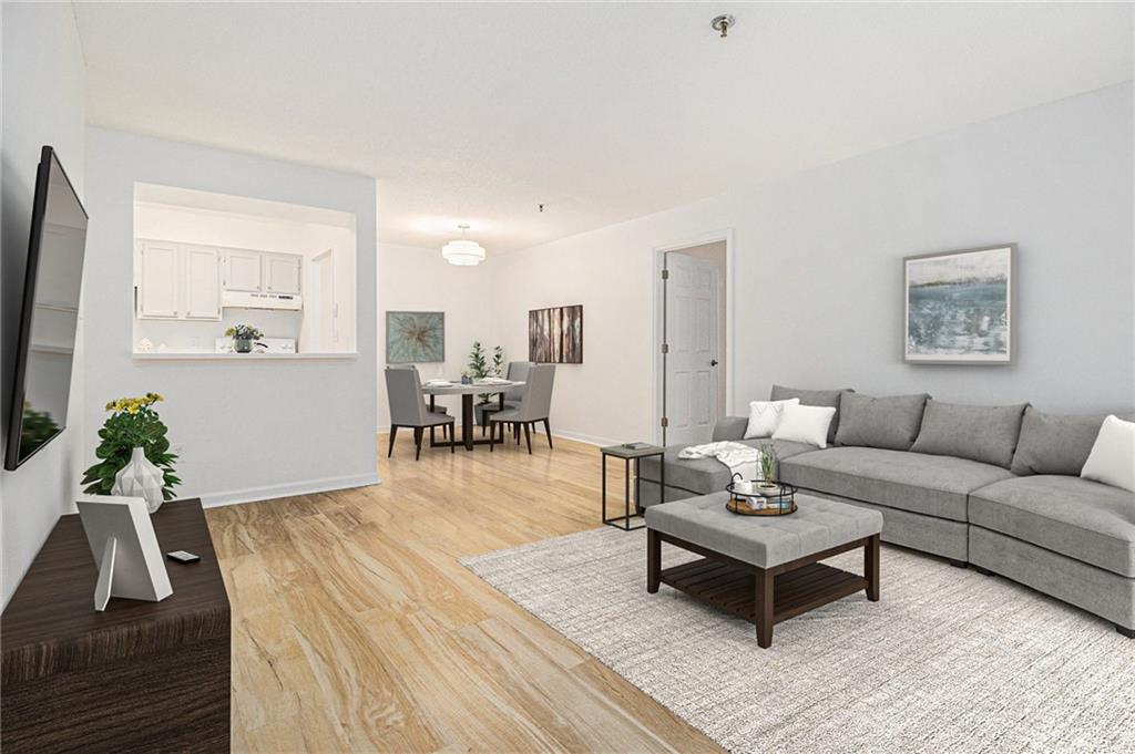 a living room with furniture and wooden floor