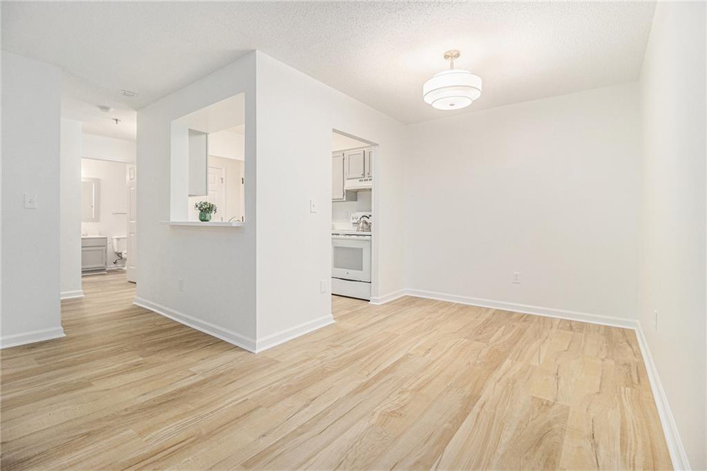 300 Johnson Ferry Road, Unit A203 Sandy Springs, GA 30328 - Photo 4 of 14 an empty room with wooden floor and windows