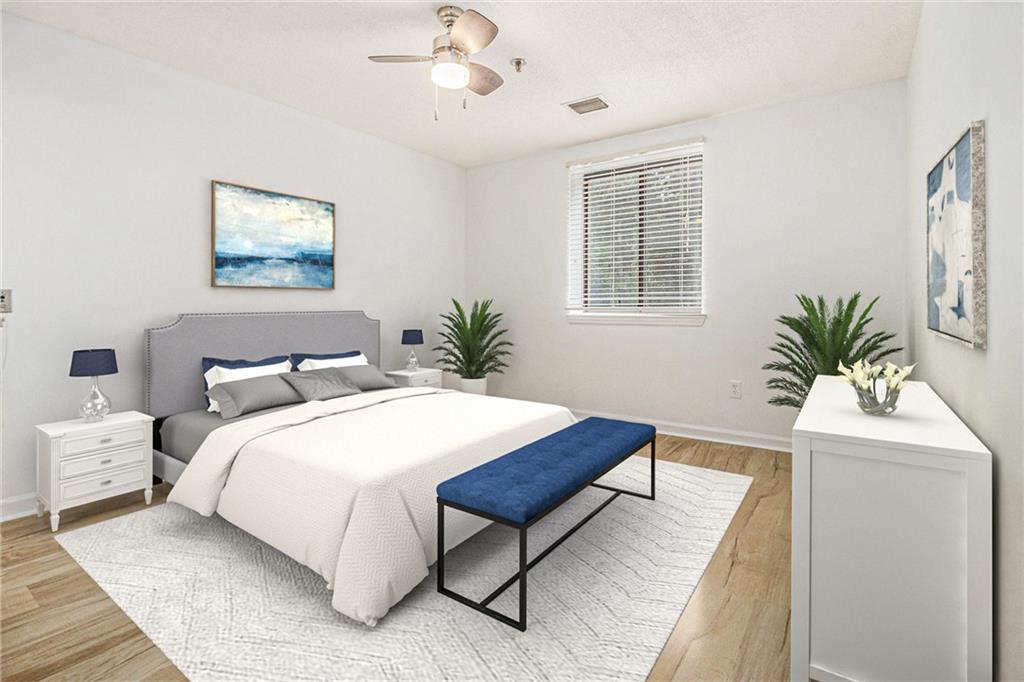 300 Johnson Ferry Road, Unit A203 Sandy Springs, GA 30328 - Photo 6 of 14 a bedroom with a large bed and a potted plant