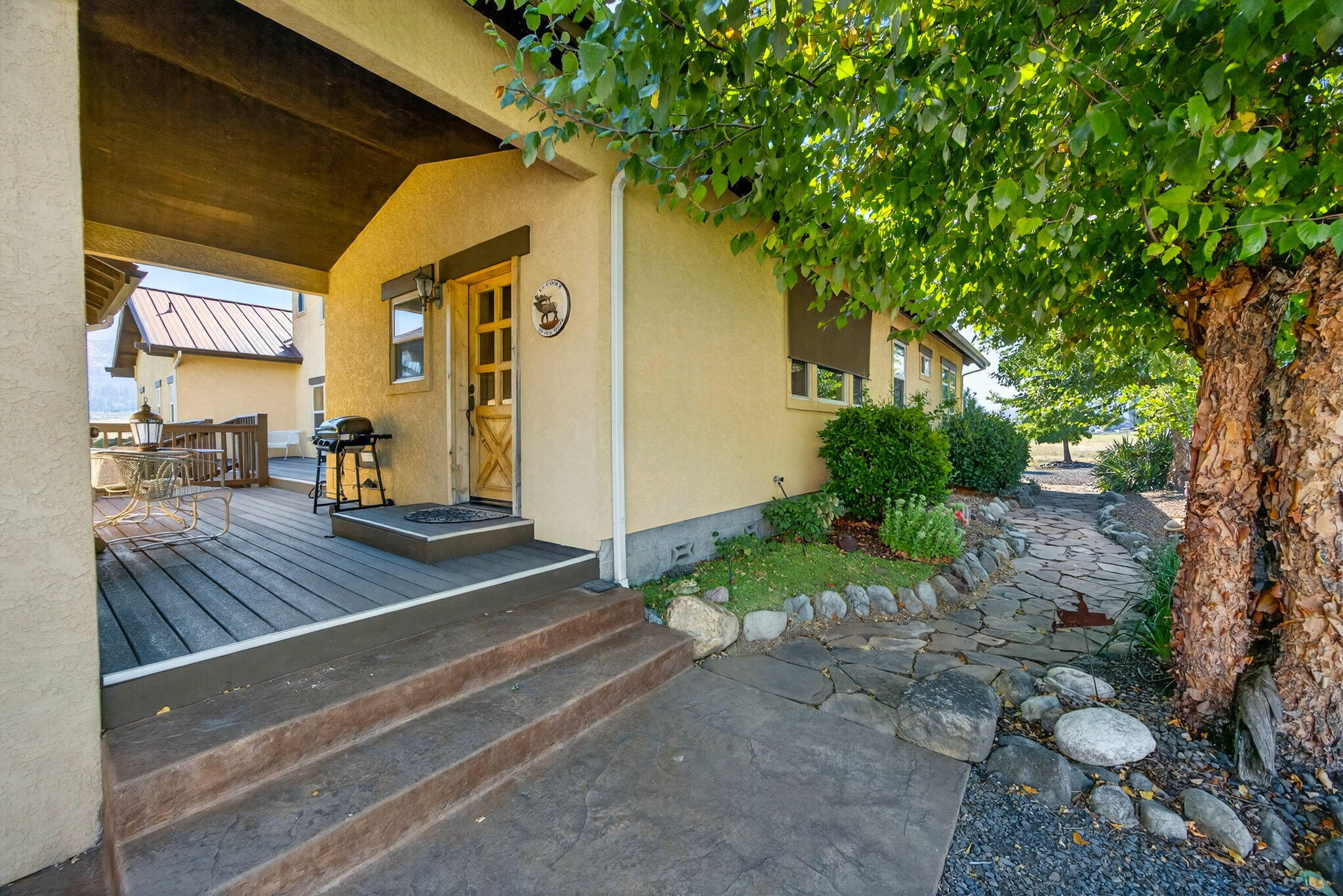 1176 Hamilton Road Jacksonville, OR 97530 - Photo 6 of 125 a view of a porch with furniture and a tree