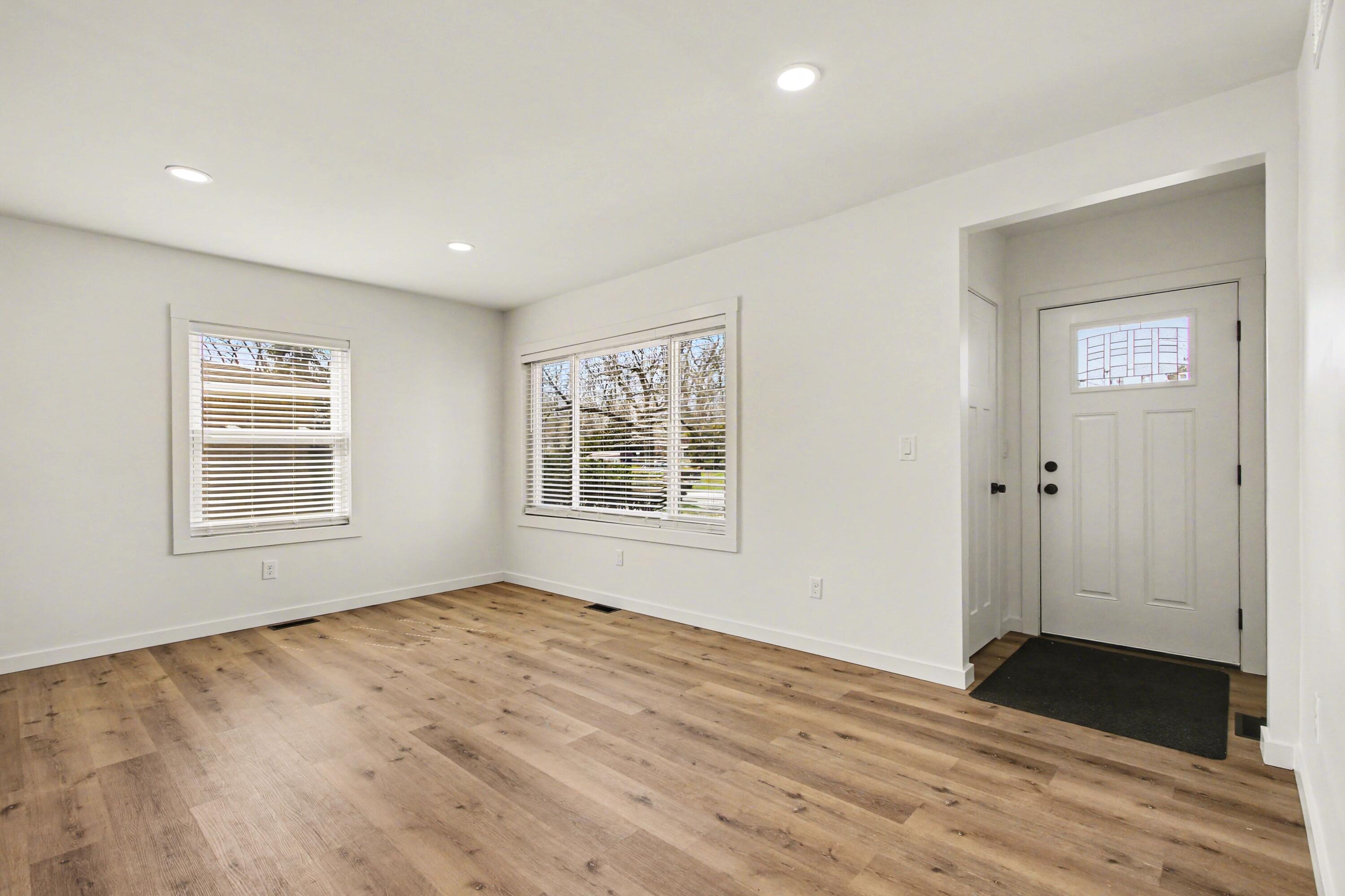 3517 Buchanan Street Gary, IN 46408 - Photo 3 of 18 a view of an empty room with wooden floor and a window