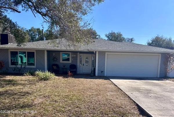 a front view of a house with a yard in front of it