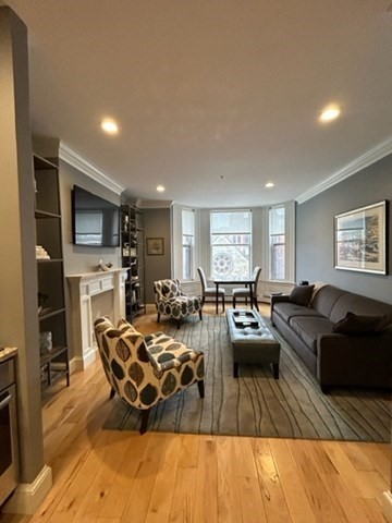 483 Beacon Street, Unit 41 Boston, MA 02115 - Photo 1 of 7 a living room with furniture fireplace and a flat screen tv