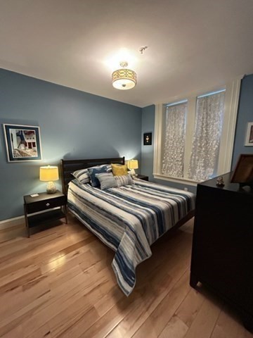 483 Beacon Street, Unit 41 Boston, MA 02115 - Photo 7 of 7 a bedroom with a bed and a flat screen tv