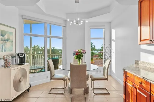 a view of a dining room with furniture a chandelier and wooden floor