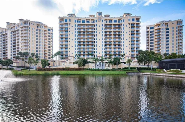 a view of a city with tall buildings and a lake