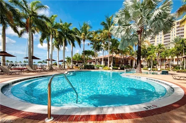 a swimming pool with outdoor seating and yard
