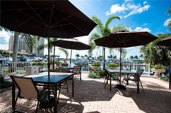 a view of a patio with chairs and table under an umbrella