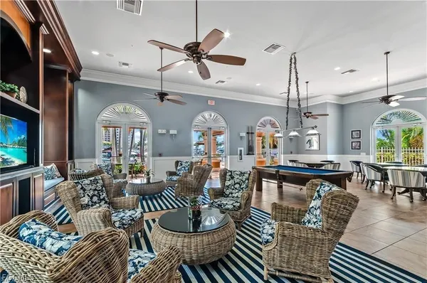 a living room with lots of furniture and a chandelier