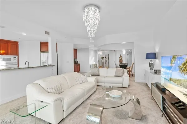 a living room with furniture a dining table and chairs