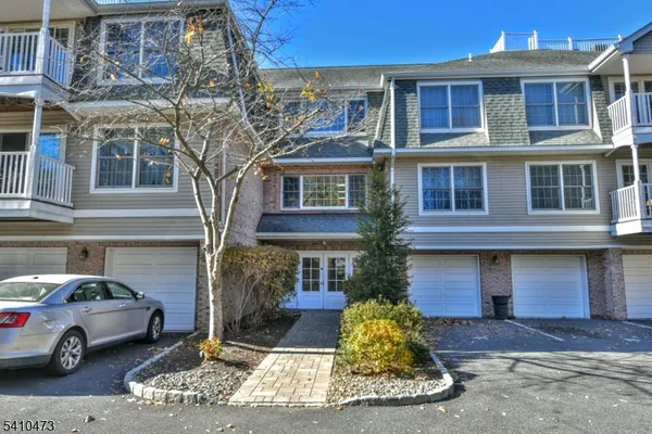 a front view of a residential apartment building with a yard