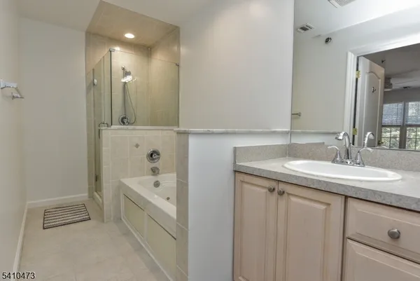 a bathroom with 2 sink tub and a mirror
