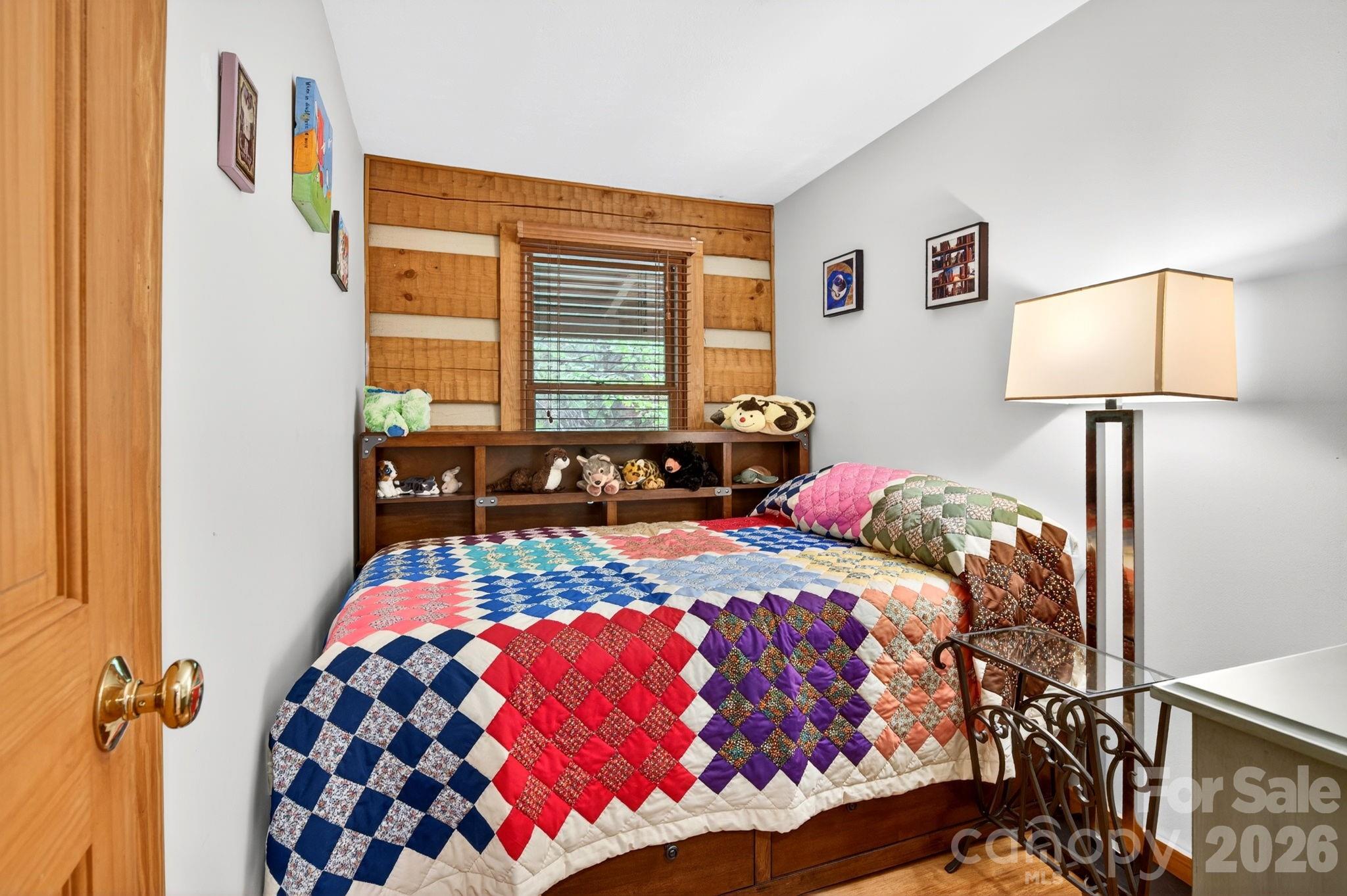 14 Weeping Cherry Forest Road Fairview, NC 28730 - Photo 20 of 44 a bedroom with a bed and wooden floor