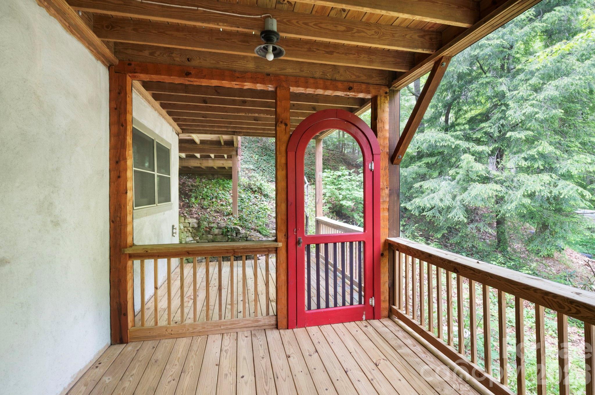 14 Weeping Cherry Forest Road Fairview, NC 28730 - Photo 10 of 44 a view of a porch with wooden floor and outdoor space